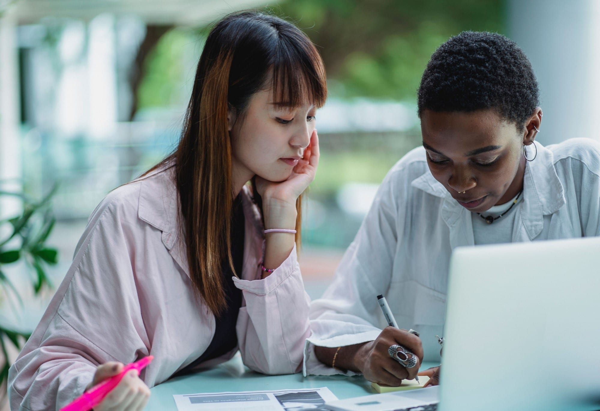 Two adult learners working through their notes together