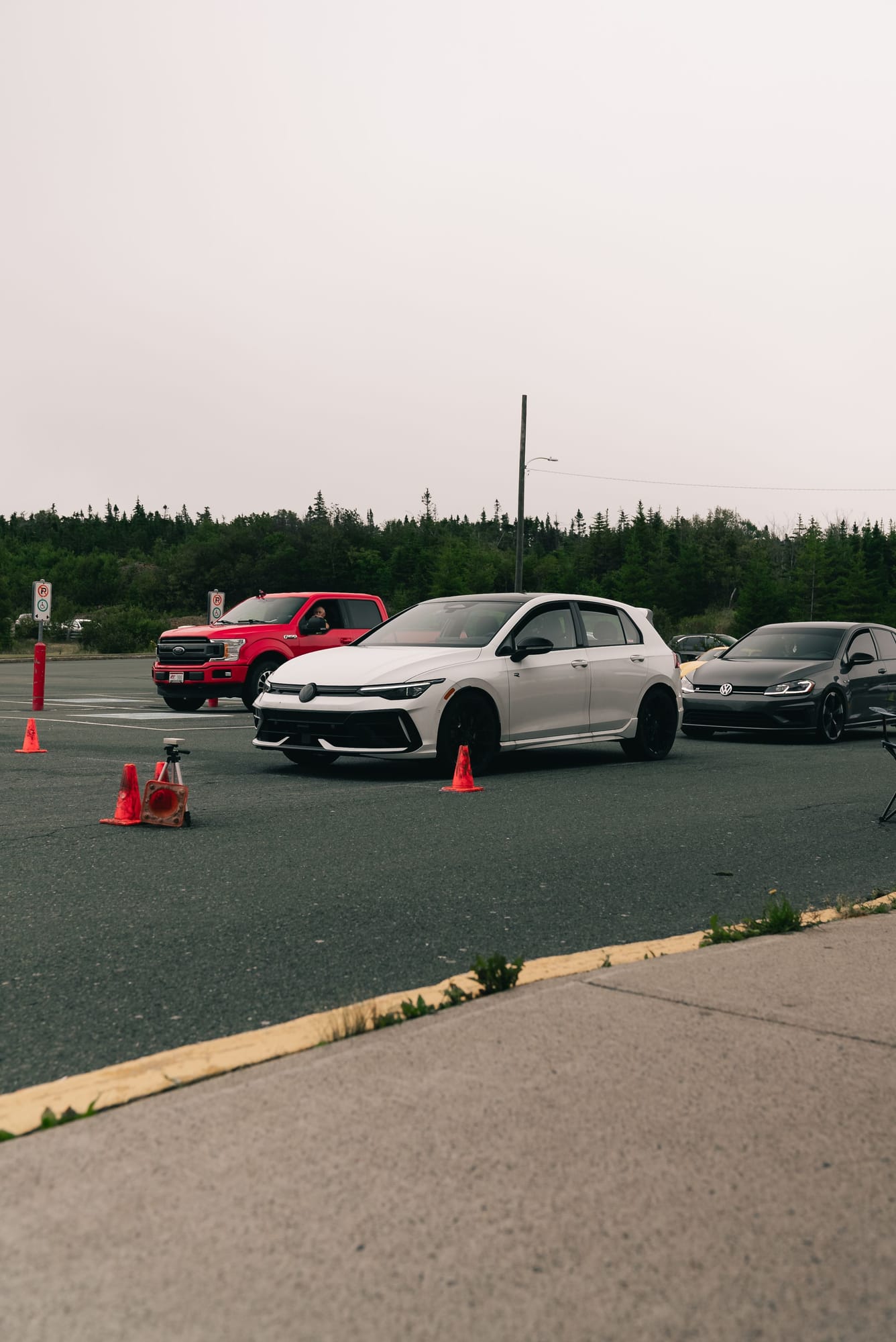 Cars on a driving practice course marked out with cones