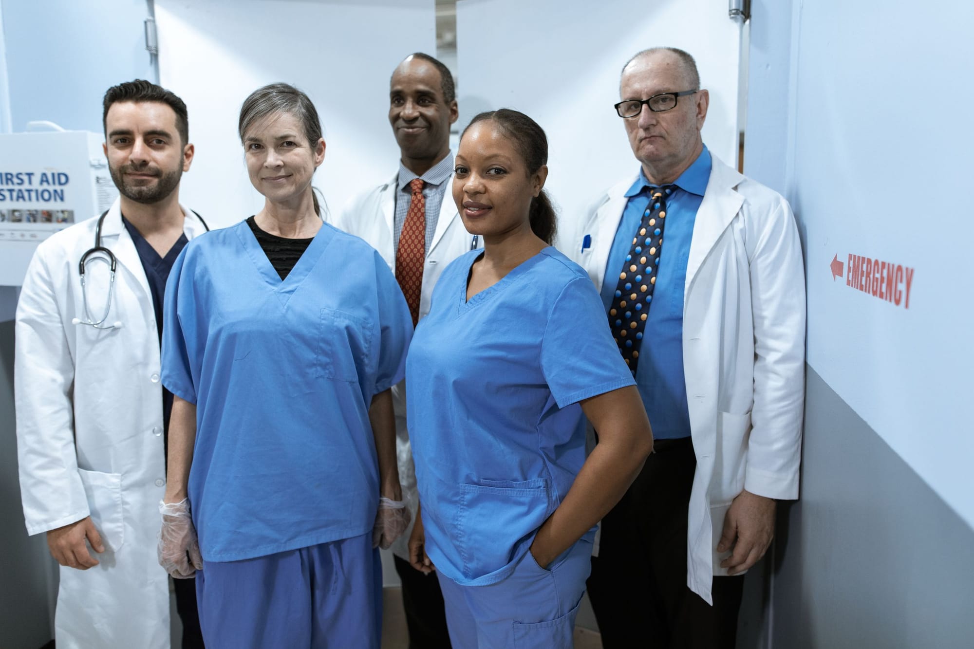 A team of nurses and doctors standing together in a hospital corridor