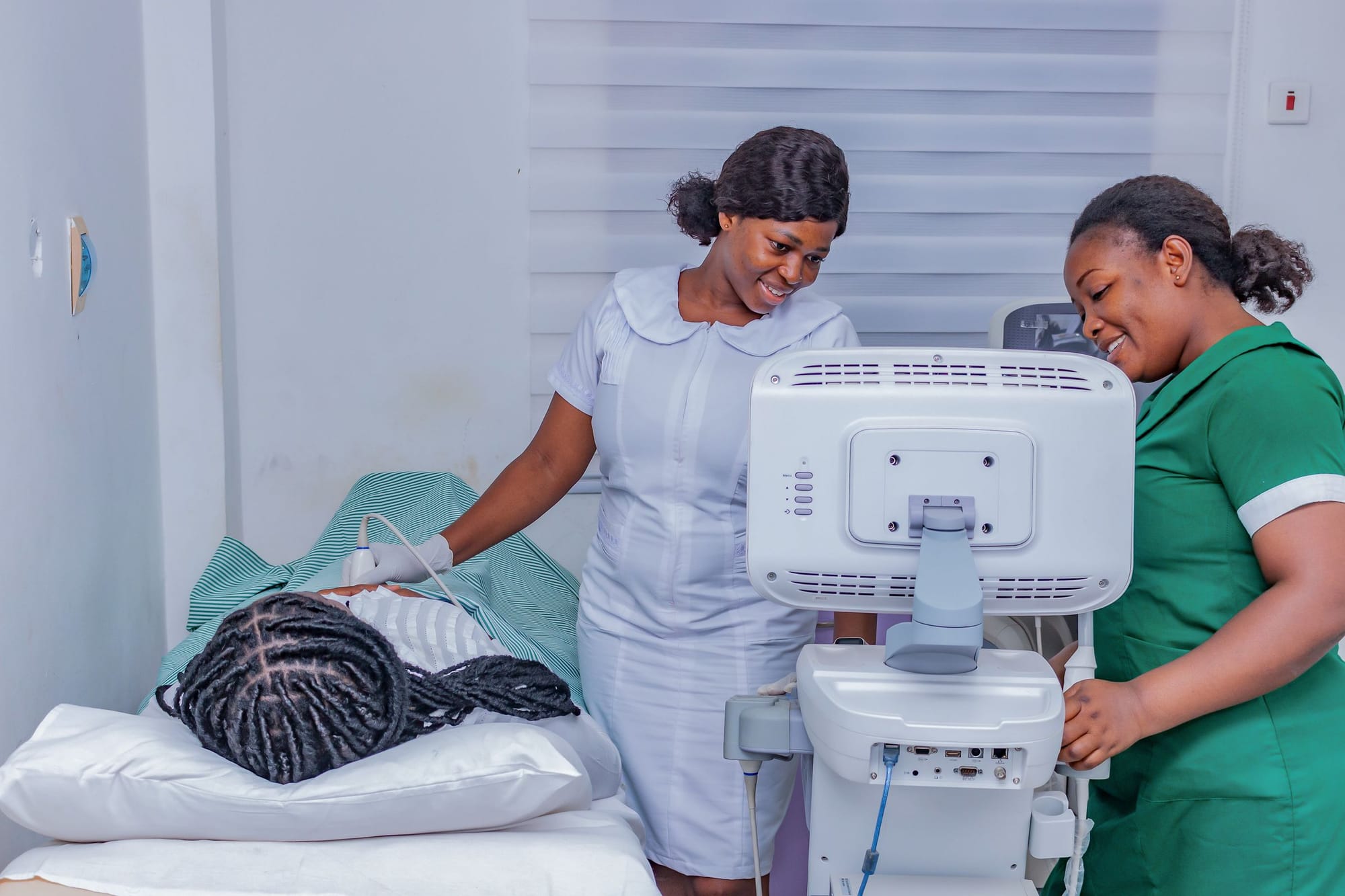 Two nurses smiling while running an ultrasound check