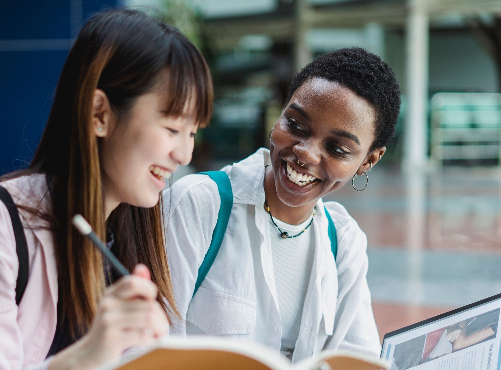 A student smiling at a classmate while they study