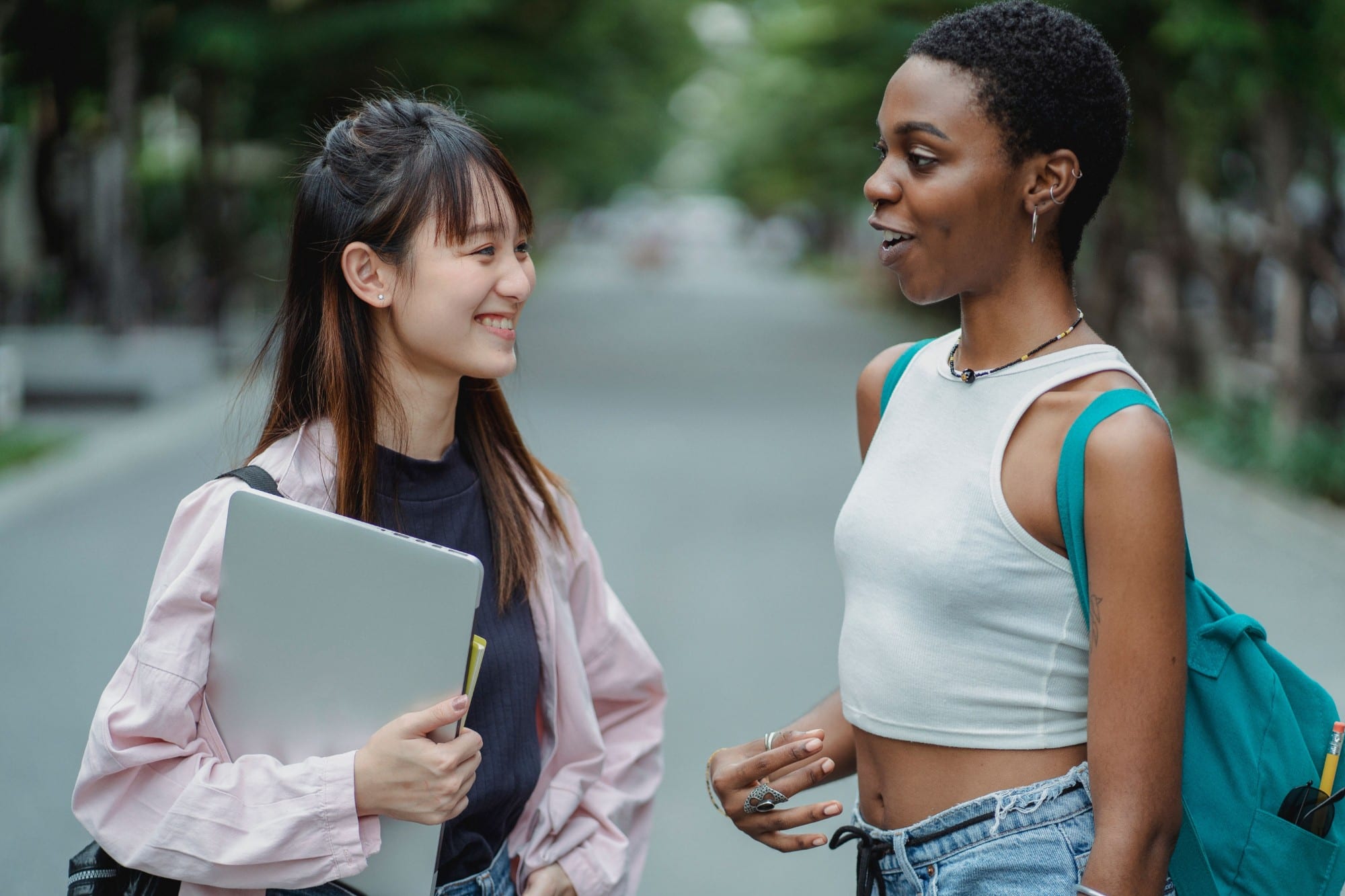 A student with her laptop chatting with a friend
